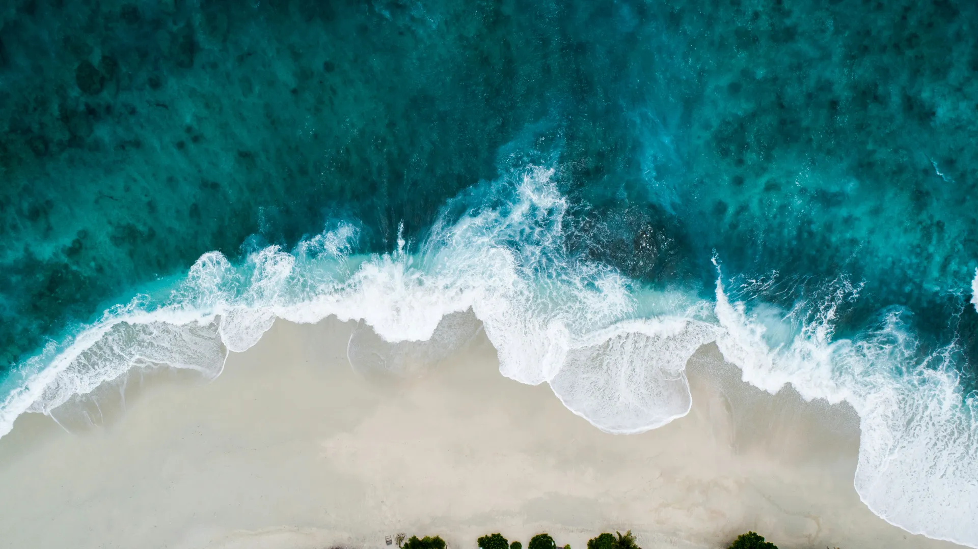 Turquoise Mediterranean waves meeting the sand on a Cyprus beach